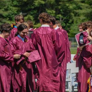 Students embrace and celebrate after the ceremony. 