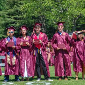 Graduates pose for a picture after receiving their diplomas. 