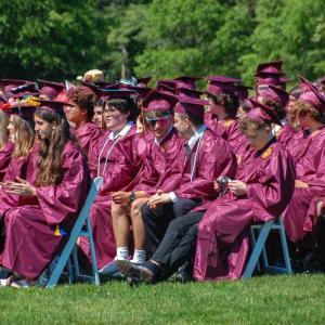 Rows of graduates wait for their names to be called. 