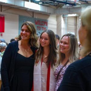 A graduate poses for a photo. 