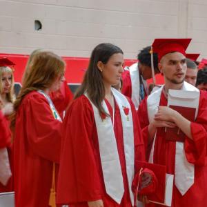 Graduated students head out of the gym. 