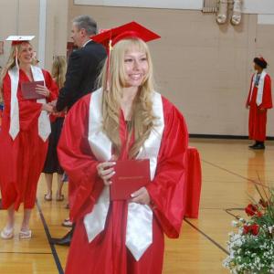 Students shake hands with school administrators and pose for photos during the ceremony. 