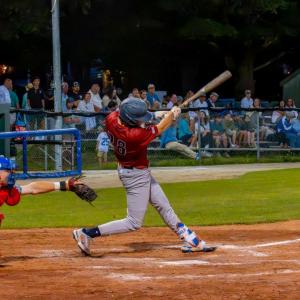 Returner Caden McDonald hits a ball to left field.