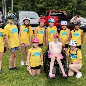 Classmates and friends surround Vivian Jones, center, at the June 2025 Kids Pan-Mass Challenge, a bike-a-thon that raises money for cancer research and treatment. Photos source: Jennifer Jones.