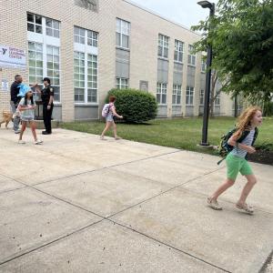 Kids run out of Sippican School after an early dismissal. 