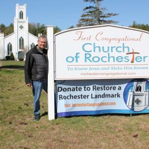 Pastor Colby Olson, right, trustee Michael Costa erect a fundraising banner with the church in the background. Photos source: First Congregational Church of Rochester
