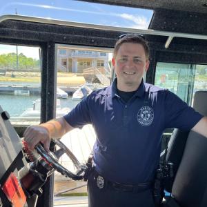 Cameron Wentworth poses in the harbormaster's boat. Photo by Grace Roche