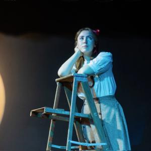 Emily gazes at the night sky after a conversation with George. 