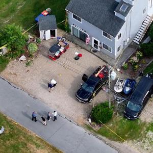 Officials investigate 10 Harbor Road, where the shooting occurred on June 30. Photo by David Curran