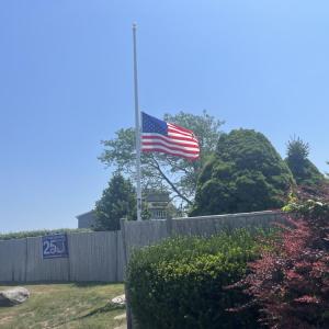 The Harbor Beach flag flies at half-mast in honor of James Rizza. Photo by Grace Roche