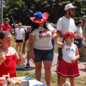 Attendees in patriotic garb ring bells at the Rochester event. 