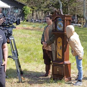 Salustiano Berrios as Michael Wainer with the grandfather clock.