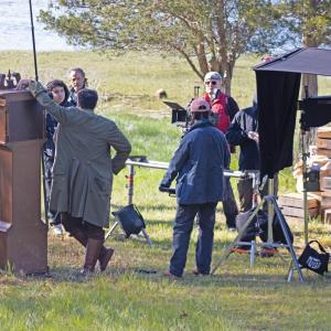 Crew members go over a scene on the bank of Slocums River.