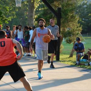 Dame Perry takes the ball up court. 