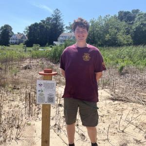 Iain McManus stands next to one of his photo posts at Brainard Marsh. Photos by Grace Roche