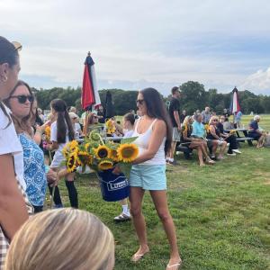 NonePeople passed out sunflowers among the crowd gathered at the sports complex. 