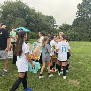Becky Eitas embraces some of her daughter's former teammates. 
