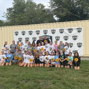 Madelyn's former teammates smile for a photo with her family.