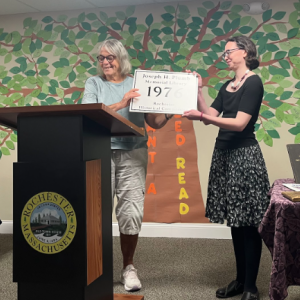 Library Director Kristen Cardoso accepts a plaque from the Rochester Historical Commission on Saturday, Aug. 22. Photo by Tanvi Kulkarni
