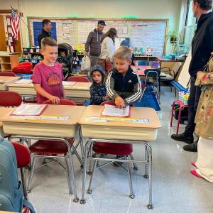 Students find their new desks. 