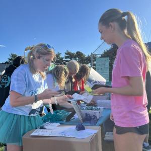 A runner picks up her number before the race.