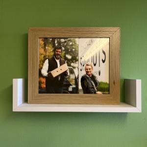 Reilley displays a photo of her former business partner Rich Wolfe in her office at the farm. 