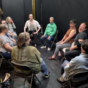 A group of people sitting in a circle wanting to do improv!