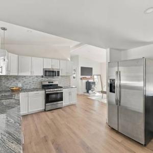 Kitchen with stainless appliances, open to the living area, at 226 Sanford Road in Westport, MA