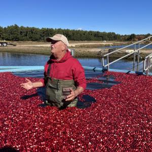 Woody Hartley, surrounded by cranberries, talks to a group visiting the farm Thursday, Oct. 15. Photos by Grace Roche