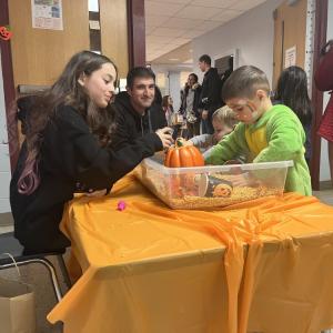 Kids play in a harvest-themed sensory bin. 