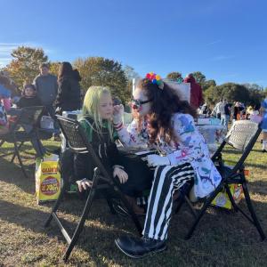 A costumed clown painted kids' faces at the event. 