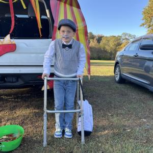 Robert Caldas, 7, leans on his walker in his old man costume. 