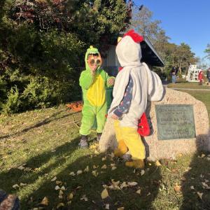 3-year olds Calvin Swegles, the dinosaur on the left, and Henry Kearns, the chicken, play together at the trunk or treat. 