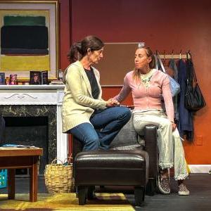 Two actors are onstage talking. 