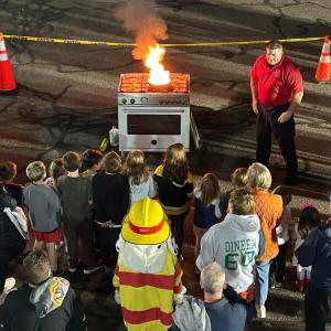 Captain Brooks Wilson demonstrates how to put out a cooking fire at the Oct. 9 open house. Photos source: Marion Fire Department