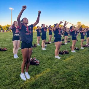 Sophomore Nassira Delgado interacts with the crowd. She said she feels different stepping onto the field with her uniform, and it allows her to be more performative. “You can hear the crowd cheering you on. It’s a great experience,” she said.