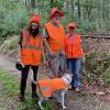 Group of hikers and their dog wear orange during hunting seaso. File photo