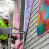 Matt Moyer Bell, Massachusetts Design, Art, and Technology Institute's programs coordinator, installs part of the “Being Seen” display outside the Marion Art Center on Wednesday, Jan. 14. Photos by Grace Roche