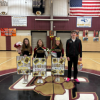 From left: cheerleaders Audrey Perkins, Ashley Marsalino and Kyla Troup, and basketball player Ryan Manchester pose together. 