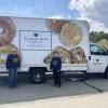 Maureen Vieira, left, and Nora DuPont stand beside the mobile food pantry at the Rochester Council on Aging. Photos by Grace Roche