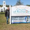 Pastor Colby Olson, right, trustee Michael Costa erect a fundraising banner with the church in the background. Photos source: First Congregational Church of Rochester