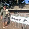 Stan Bradford holds his dog Goodness in front of his Kindness Wall at his property at 468 Wareham Road. Photos by Grace Roche