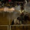 A rider shoots a gun during the Sept. 19 rodeo. Photo by Benjamin Martins