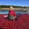 Woody Hartley, surrounded by cranberries, talks to a group visiting the farm Thursday, Oct. 15. Photos by Grace Roche