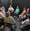 A circle of actors gets ready to IMPROV